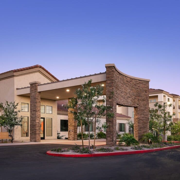 A welcoming entrance surrounded by greenery, inviting residents to a warm, supportive community.