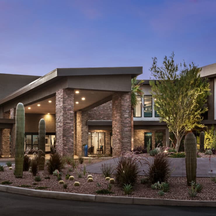 A welcoming entrance surrounded by lush landscaping, inviting residents to enjoy community life.